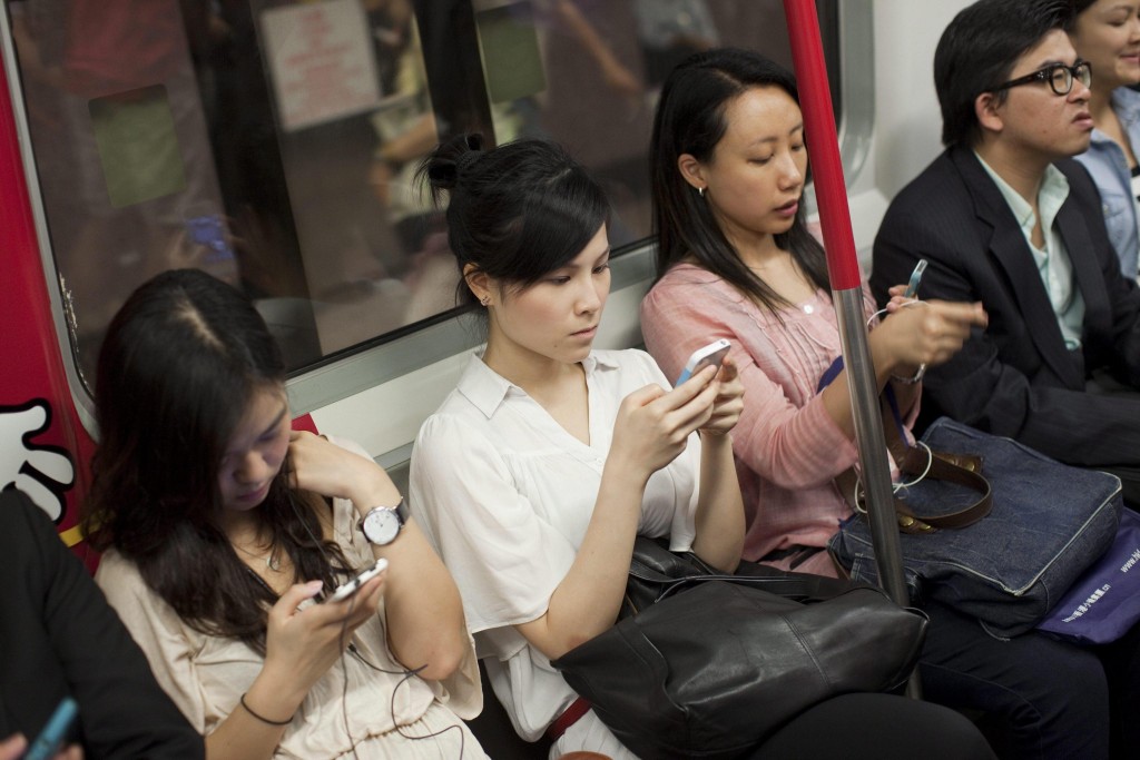 Commuters use smartphone