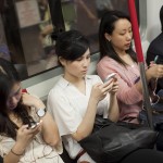 Commuters use smartphone