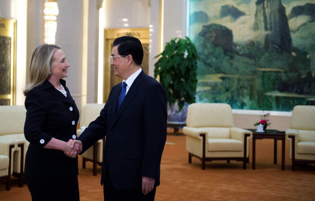 U.S. Secretary of State Clinton shakes hands with Chinese President Hu during a bilateral meeting in Beijing